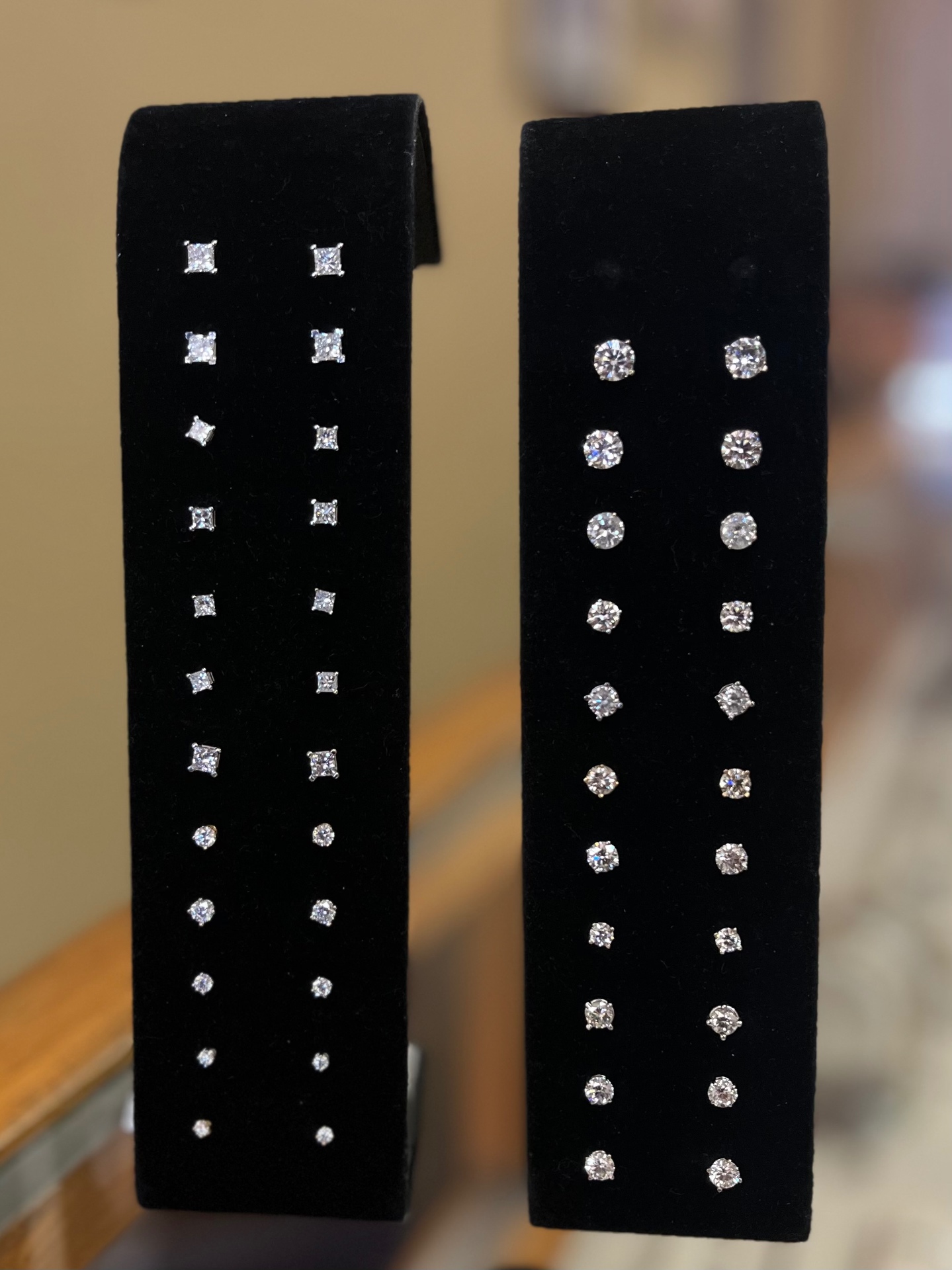 Diamond stud earrings collection on black velvet display