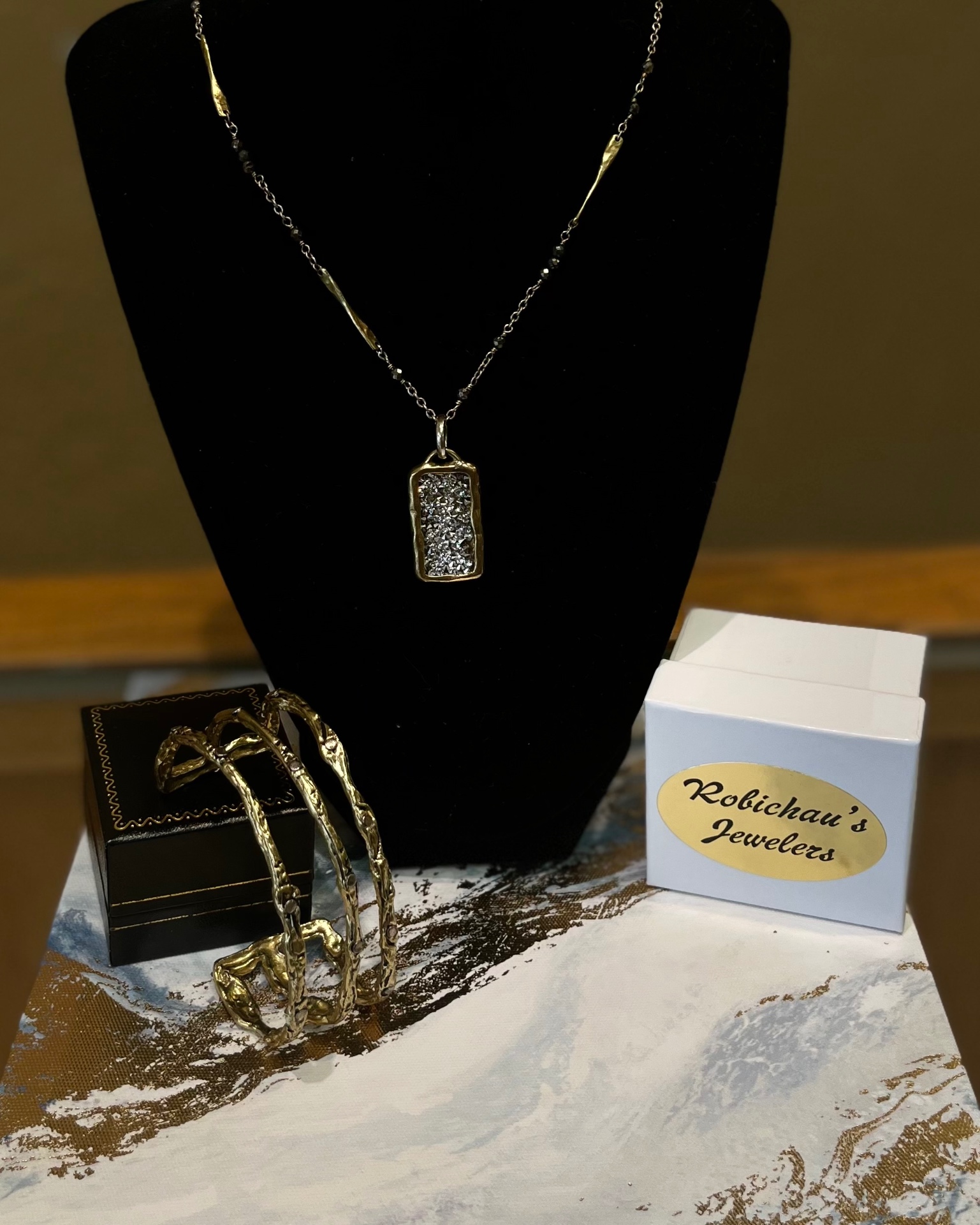 Gold and diamond pendant necklace with Robichau's Jewelers box